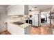 Kitchen with white cabinets, breakfast bar, and view into dining area at 36444 N Stardust Ln, Carefree, AZ 85377