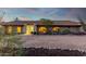 Front view of a ranch-style home with a curved driveway and desert landscaping at 36444 N Stardust Ln, Carefree, AZ 85377