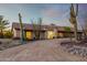 Front view of a ranch-style home with a curved driveway and desert landscaping at 36444 N Stardust Ln, Carefree, AZ 85377
