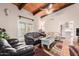 Sunlit living room with leather sofas and access to a patio at 36444 N Stardust Ln, Carefree, AZ 85377