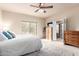 Bright bedroom with a queen bed, access to a patio, and built-in storage at 36444 N Stardust Ln, Carefree, AZ 85377