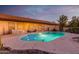 Lush backyard oasis featuring a kidney-shaped pool and patio furniture at 36444 N Stardust Ln, Carefree, AZ 85377
