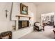 Elegant fireplace with ornate mantel and a comfortable armchair at 36444 N Stardust Ln, Carefree, AZ 85377