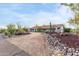 Front view of a ranch-style home with a curved driveway and desert landscaping at 36444 N Stardust Ln, Carefree, AZ 85377
