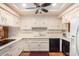 White kitchen with ample counter space and black appliances at 36444 N Stardust Ln, Carefree, AZ 85377