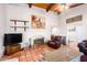 Charming living room with a wood-beamed ceiling and fireplace at 36444 N Stardust Ln, Carefree, AZ 85377