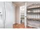 Well-lit pantry with ample shelving for storage at 36444 N Stardust Ln, Carefree, AZ 85377
