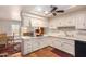 Galley kitchen with white cabinets, tile floors, and a ceiling fan at 36444 N Stardust Ln, Carefree, AZ 85377