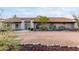 Front view of a ranch-style home with a curved driveway and desert landscaping at 36444 N Stardust Ln, Carefree, AZ 85377