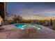 Relaxing pool area with patio furniture and desert landscaping at 36444 N Stardust Ln, Carefree, AZ 85377