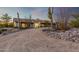 Front view of a ranch-style home with a curved driveway and desert landscaping at 36444 N Stardust Ln, Carefree, AZ 85377