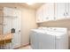 Laundry room with washer, dryer, and cabinets at 36444 N Stardust Ln, Carefree, AZ 85377