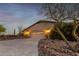 Two-car garage with stamped concrete driveway and desert landscaping at 36444 N Stardust Ln, Carefree, AZ 85377