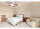 Bedroom with a queen bed, armchair, and dresser at 36444 N Stardust Ln, Carefree, AZ 85377