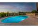 Inviting kidney shaped pool with surrounding patio and desert landscape at 36444 N Stardust Ln, Carefree, AZ 85377