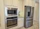 Built-in microwave and oven with stainless steel refrigerator at 10736 W Paso Trl, Peoria, AZ 85383