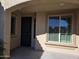 Covered entryway with tile flooring, dark door, and window with shutters at 10736 W Paso Trl, Peoria, AZ 85383