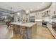 Modern kitchen with white cabinets, stainless steel appliances, and a large kitchen island at 7928 E Parkview Ln, Scottsdale, AZ 85255