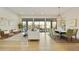 Open living space with a modern aesthetic, featuring light wood floors and large windows at 7928 E Parkview Ln, Scottsdale, AZ 85255