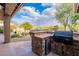 Outdoor kitchen with built-in grill and refrigerator, perfect for entertaining at 5077 E Lonesome Trl, Cave Creek, AZ 85331