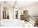 Main bedroom with plush bedding, large windows, and an elegant chandelier at 18197 W Cielo Grande Ave, Surprise, AZ 85387