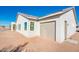 Attached garage with light taupe colored door and exterior of house at 15435 W Bajada Dr, Surprise, AZ 85387