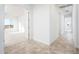 Clean hallway with tile flooring leading to bedrooms and other rooms at 15435 W Bajada Dr, Surprise, AZ 85387