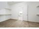 Spacious walk-in closet with built-in shelves and access to bathroom at 15435 W Bajada Dr, Surprise, AZ 85387