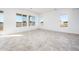 Sunlit living room featuring tile flooring and multiple windows at 15435 W Bajada Dr, Surprise, AZ 85387