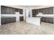 Modern kitchen with island, granite countertops and dark cabinetry at 15435 W Bajada Dr, Surprise, AZ 85387