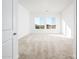 Spacious bedroom with neutral carpeting and large windows at 15435 W Bajada Dr, Surprise, AZ 85387