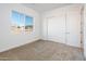 Bright bedroom with carpeted floor, large closet, and window with view at 15435 W Bajada Dr, Surprise, AZ 85387
