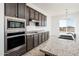 Modern kitchen with dark cabinets and granite countertops at 15435 W Bajada Dr, Surprise, AZ 85387