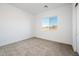 Well-lit bedroom with neutral carpeting and a window with a view at 15435 W Bajada Dr, Surprise, AZ 85387