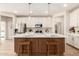 Modern kitchen with island, stainless steel appliances, and white cabinets at 18252 W Cielo Grande Ave, Surprise, AZ 85387