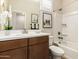 Clean bathroom with tub, single vanity, and white decor at 18252 W Cielo Grande Ave, Surprise, AZ 85387