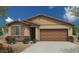 One-story home with brown garage door and landscaping at 18252 W Cielo Grande Ave, Surprise, AZ 85387