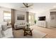 Living room with light beige couch and wooden coffee table at 18252 W Cielo Grande Ave, Surprise, AZ 85387