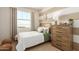 Cozy bedroom with striped wall and wood furniture at 18252 W Cielo Grande Ave, Surprise, AZ 85387