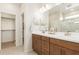Double vanity bathroom with large mirror and shower at 18252 W Cielo Grande Ave, Surprise, AZ 85387