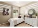 Well-lit bedroom with striped wall and guitar art at 18252 W Cielo Grande Ave, Surprise, AZ 85387