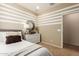 Stylish bedroom with striped wall and mirrored decor at 18252 W Cielo Grande Ave, Surprise, AZ 85387
