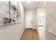 Bright entryway with hardwood floors and large artwork at 18252 W Cielo Grande Ave, Surprise, AZ 85387