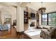 Cozy Gathering room features a stone fireplace and built-in shelving at 19481 N 98Th Pl, Scottsdale, AZ 85255