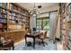 Spacious library with extensive built-in bookshelves and a comfortable workspace at 19481 N 98Th Pl, Scottsdale, AZ 85255