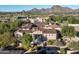 Aerial view of a stunning home with mountain views and a well manicured lawn at 19481 N 98Th Pl, Scottsdale, AZ 85255