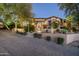 Luxury home exterior at dusk with a brick driveway at 19481 N 98Th Pl, Scottsdale, AZ 85255