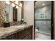 Modern bathroom with a single sink and a walk-in shower at 19481 N 98Th Pl, Scottsdale, AZ 85255