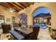 Inviting patio with outdoor dining area and a view of the pool at 19481 N 98Th Pl, Scottsdale, AZ 85255