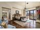 Luxurious main bedroom with hardwood floors and access to a private balcony at 19481 N 98Th Pl, Scottsdale, AZ 85255